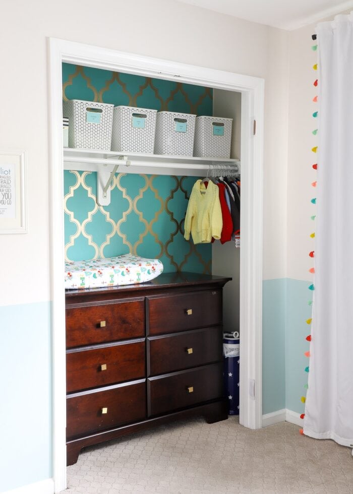 Nursery closet with dresser inside