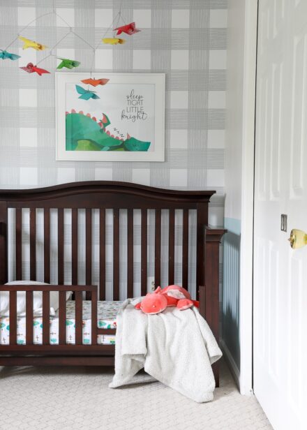 View of dark wood crib in Knight-themed nursery