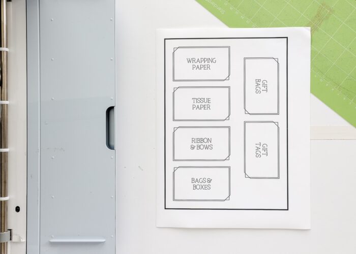 Labels printed onto white sticker paper next to Cricut Maker 3
