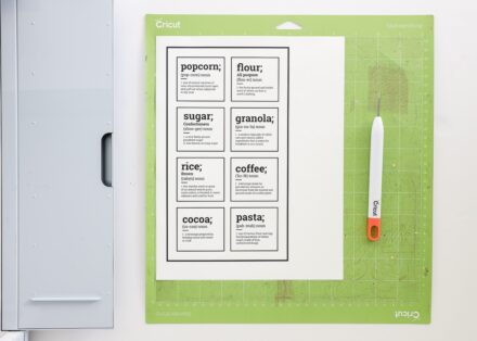 Printed pantry labels loaded onto a green Cricut cutting mat