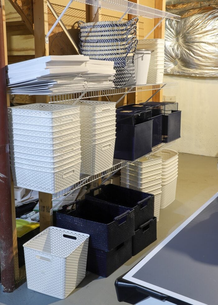 Shelves holding white and navy baskets