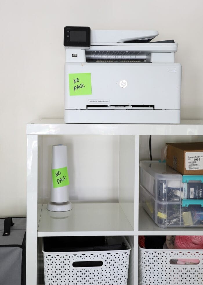 "No Pack" notes on a printer and speaker ready for professional packers