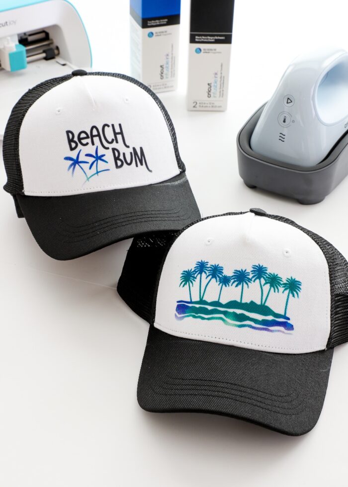 Two black trucker hats made with Cricut Hat Press & Infusible Ink Transfer Sheets
