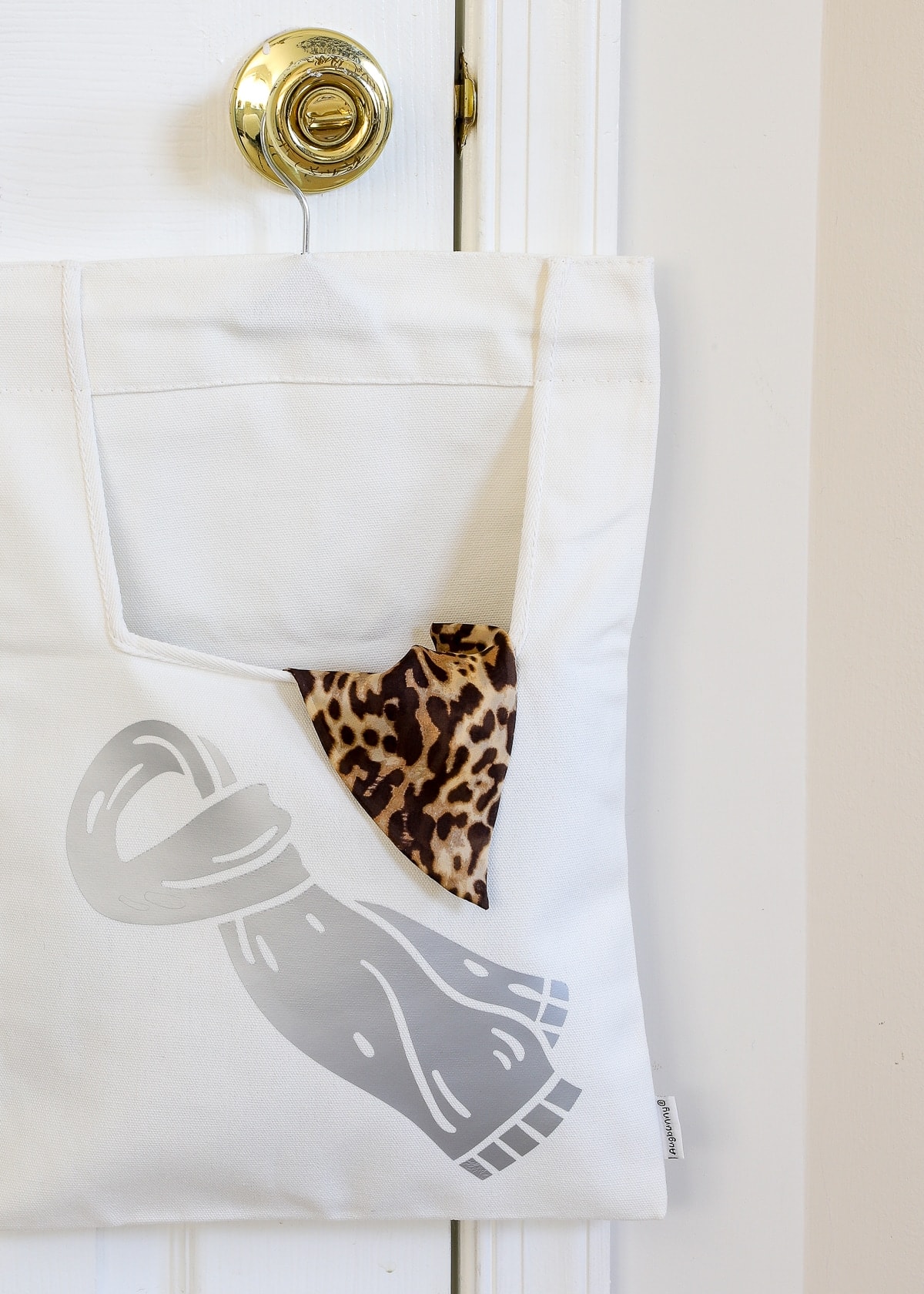 Bag holding scarves with an iron-label made with a Cricut