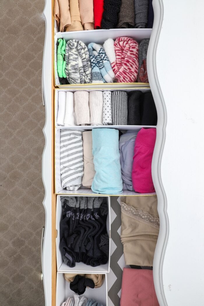 Dresser drawer organized with white gift boxes
