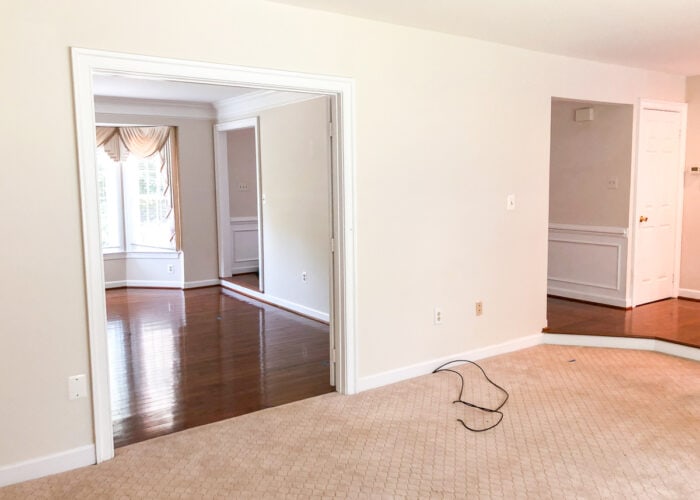 Empty family room with beige walls and beige carpet