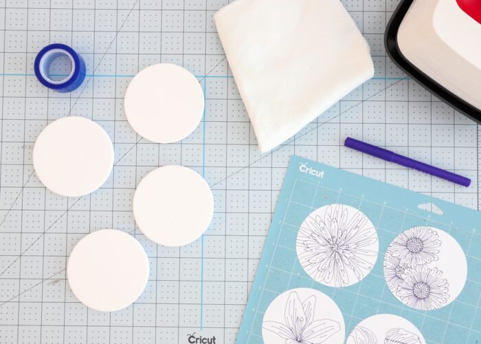 White coasters shown alongside pen designs on white laser copy paper