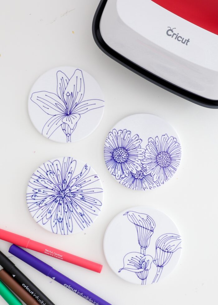 Flower coasters made with blue Cricut Infusible Ink Pens shown with Cricut EasyPress 2