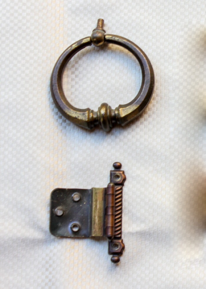 Heavily tarnished brass knob and hinge