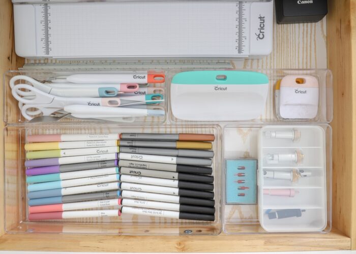 Cricut supplies organized in a drawer with clear dividers