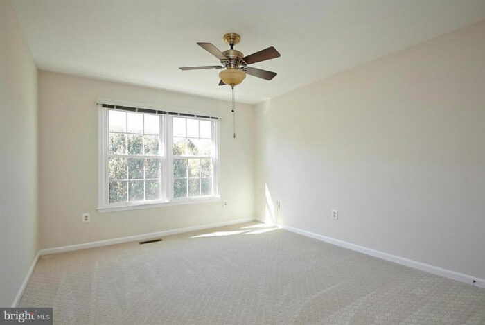 Empty room with beige walls and carpet