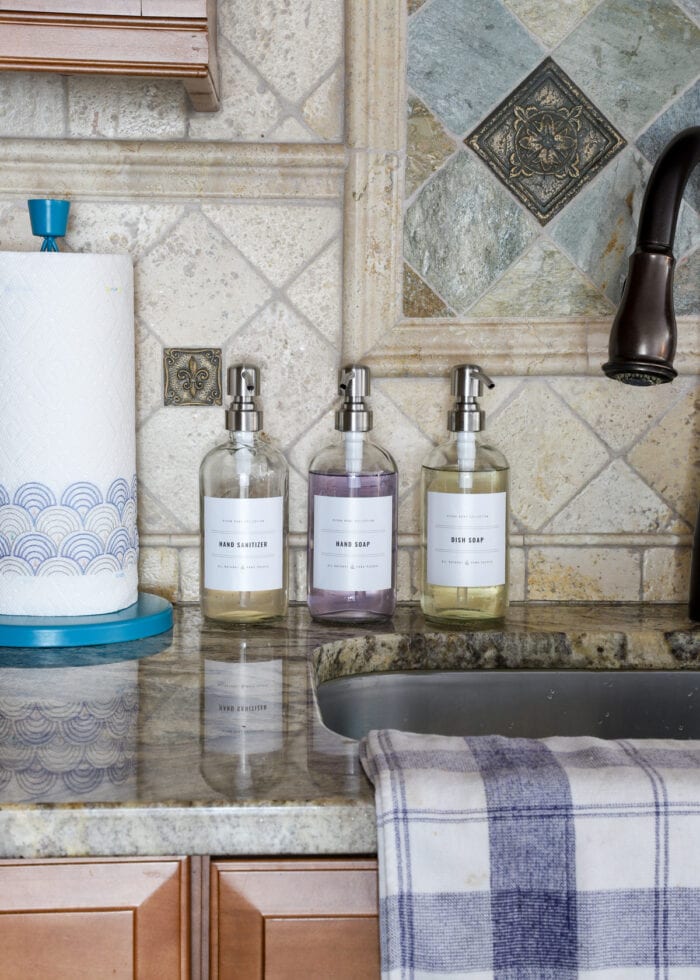 Glass soap containers next to a sink