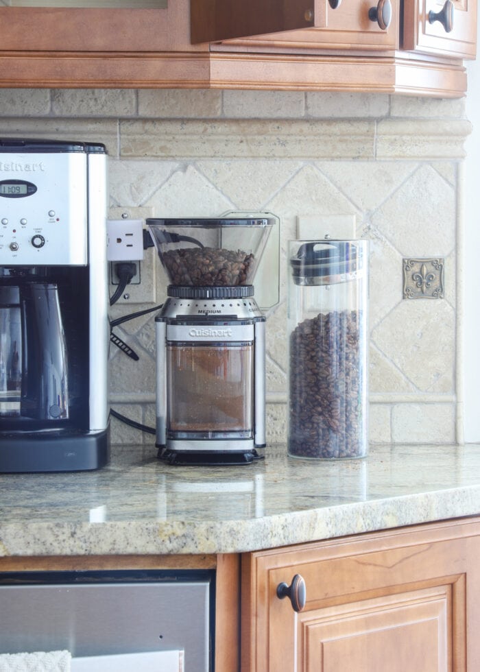 Coffee grinder and bean storage on a kitchen counter