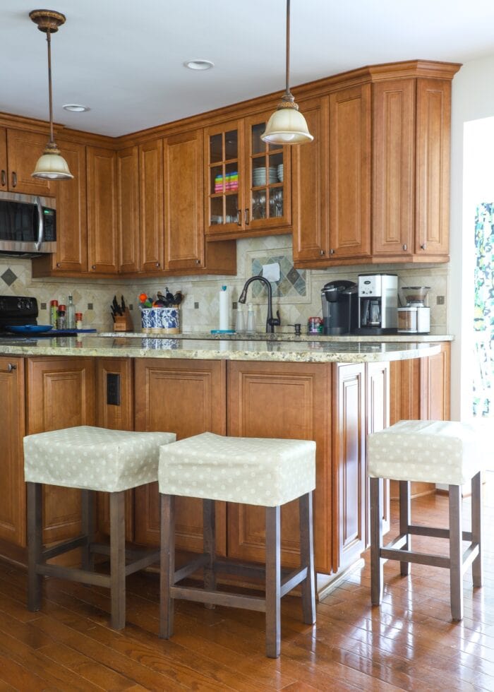 Rental kitchen with custom wood cabinets and covered bar stools
