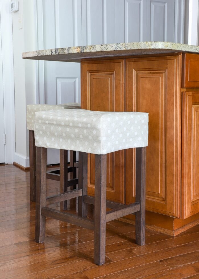 Covered barstool up against kitchen island