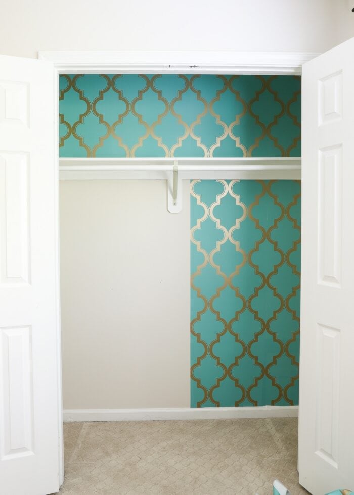 Closet with turquoise wallpaper being removed
