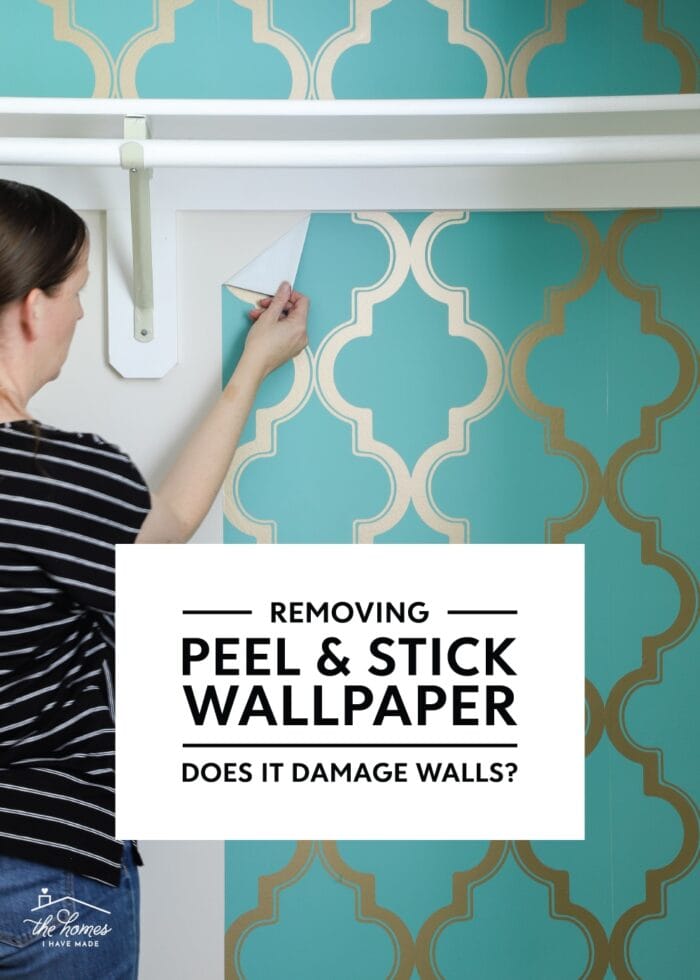 Hand pulling down peel-and-stick wallpaper