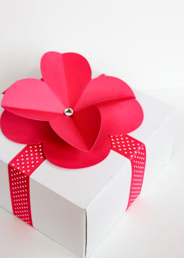 Hot pink 3D paper flower on top of a white gift box