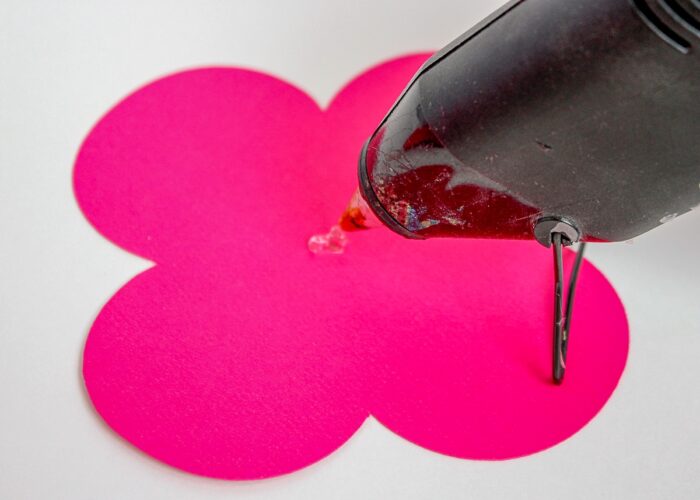 Hot glue dot on a flat pink paper flower