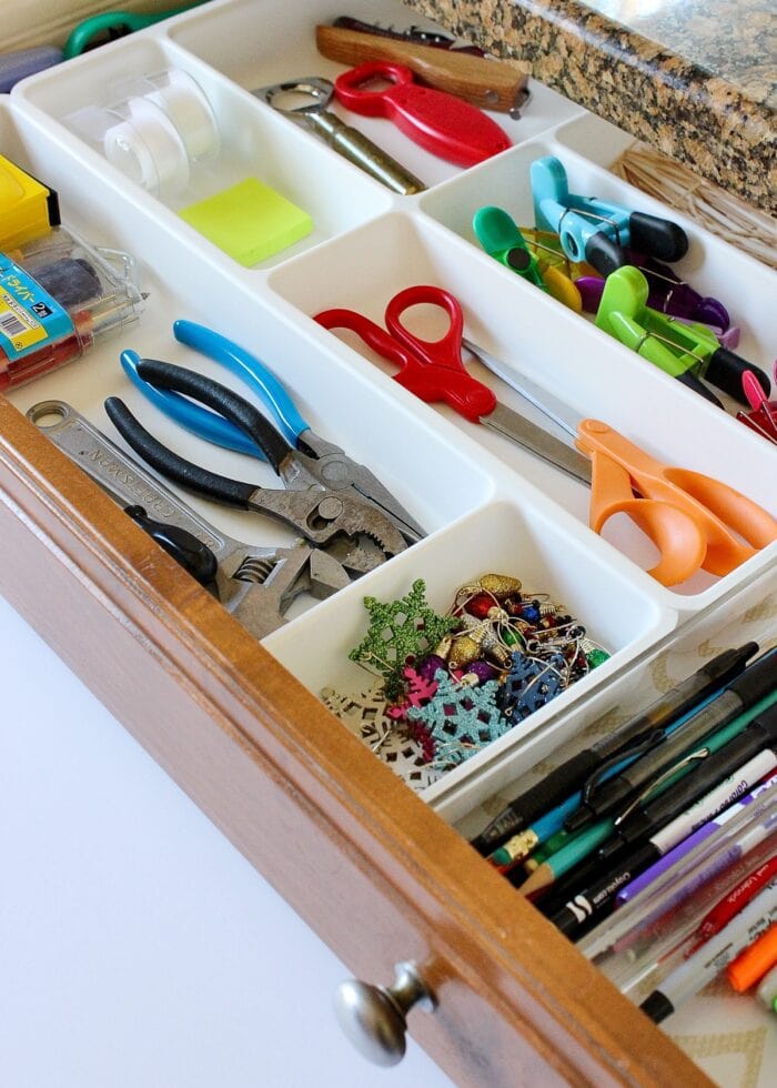 Organized junk drawer in a kitchen