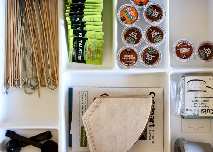 White drawer dividers holding coffee supplies
