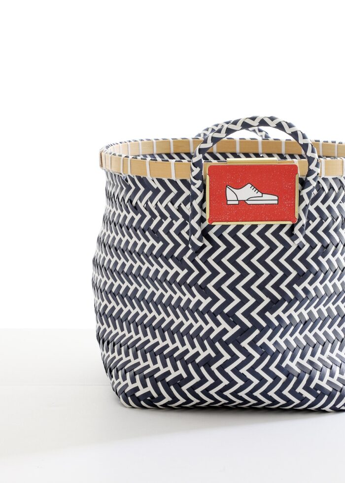 Blue and white basket with red shoe label
