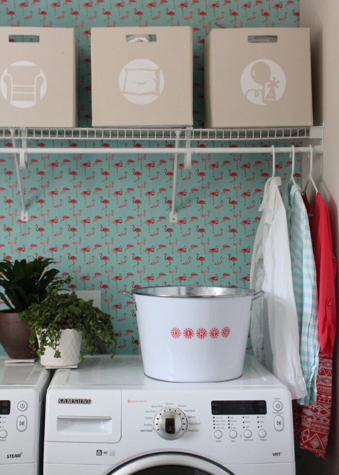 Laundry room with turquoise and pink wallpaper