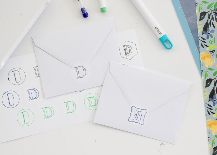 Monogram stickers on the backs of white envelopes