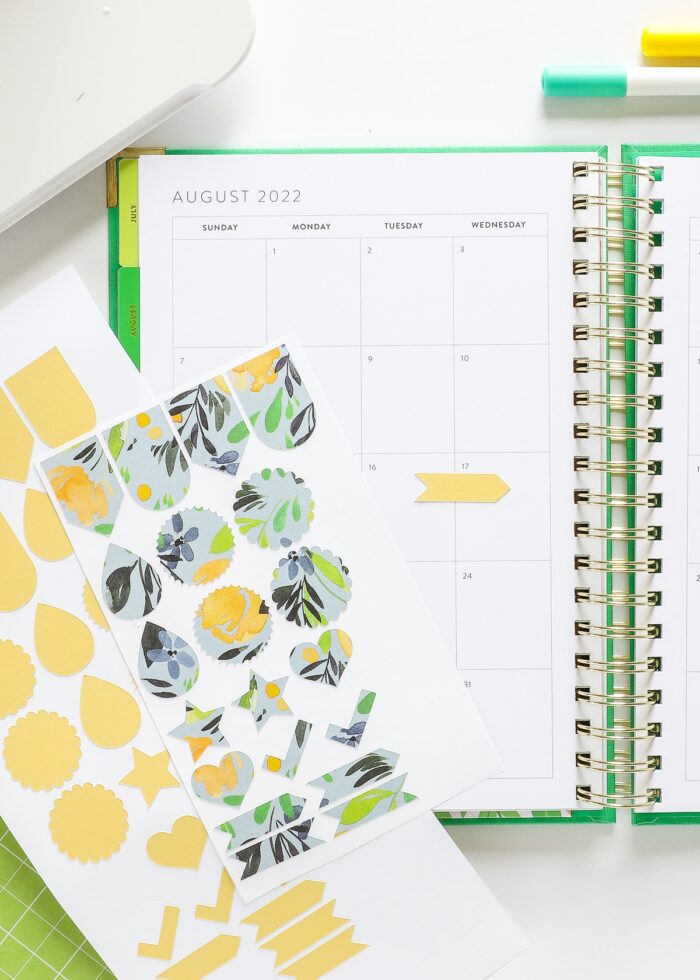 Stickers made with Cricut Joy in three different colors shown alongside a planner