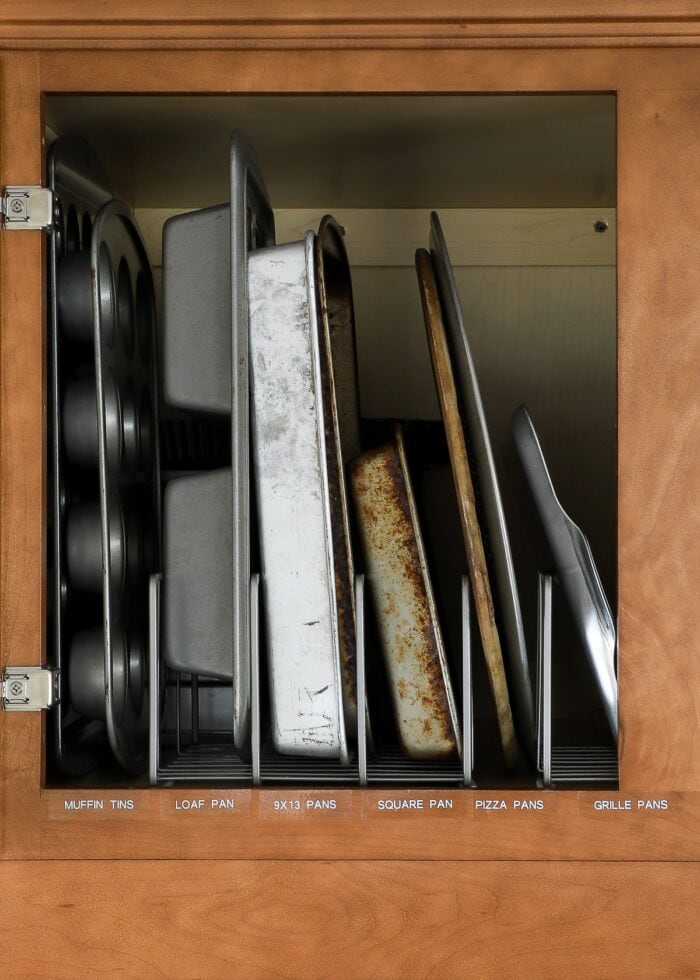 Baking pans in vertical organizers with white labels
