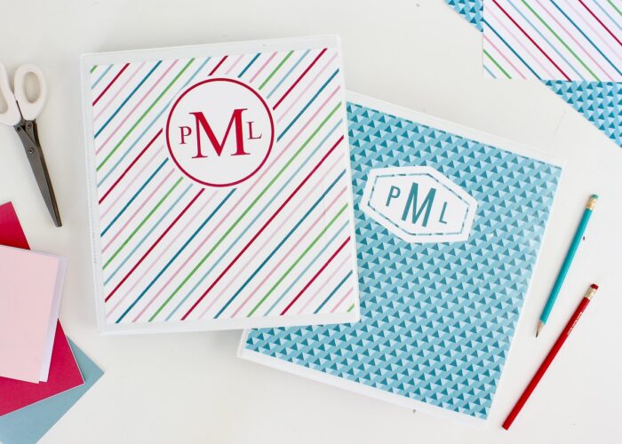A set of two binders both with monogrammed binder covers