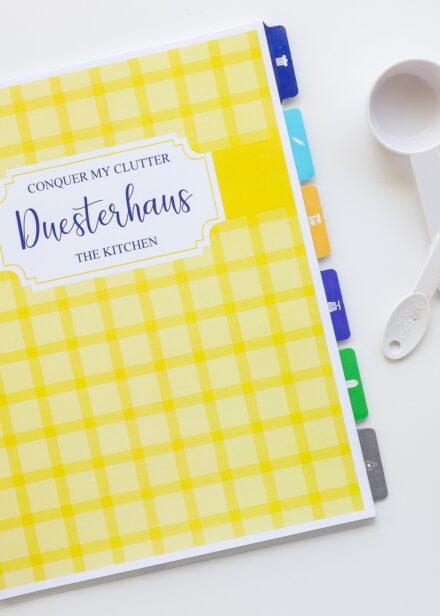 Kitchen clutter workbook organized with colorful tabs