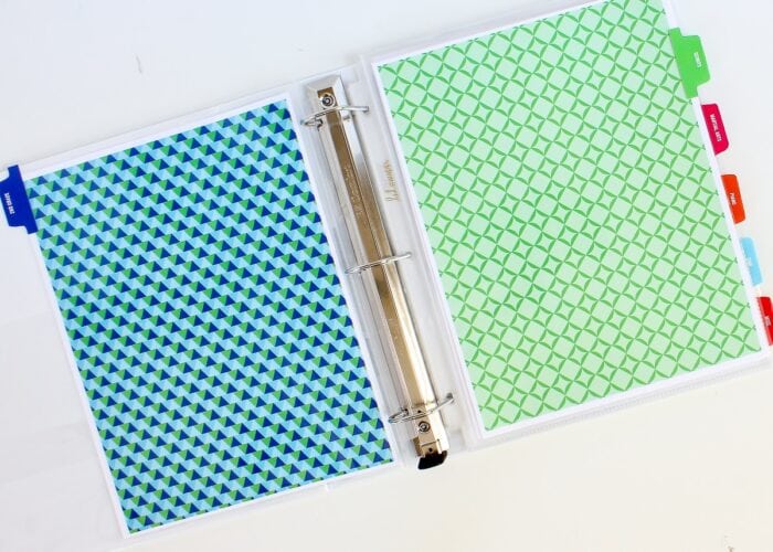 A white binder with colorful dividers