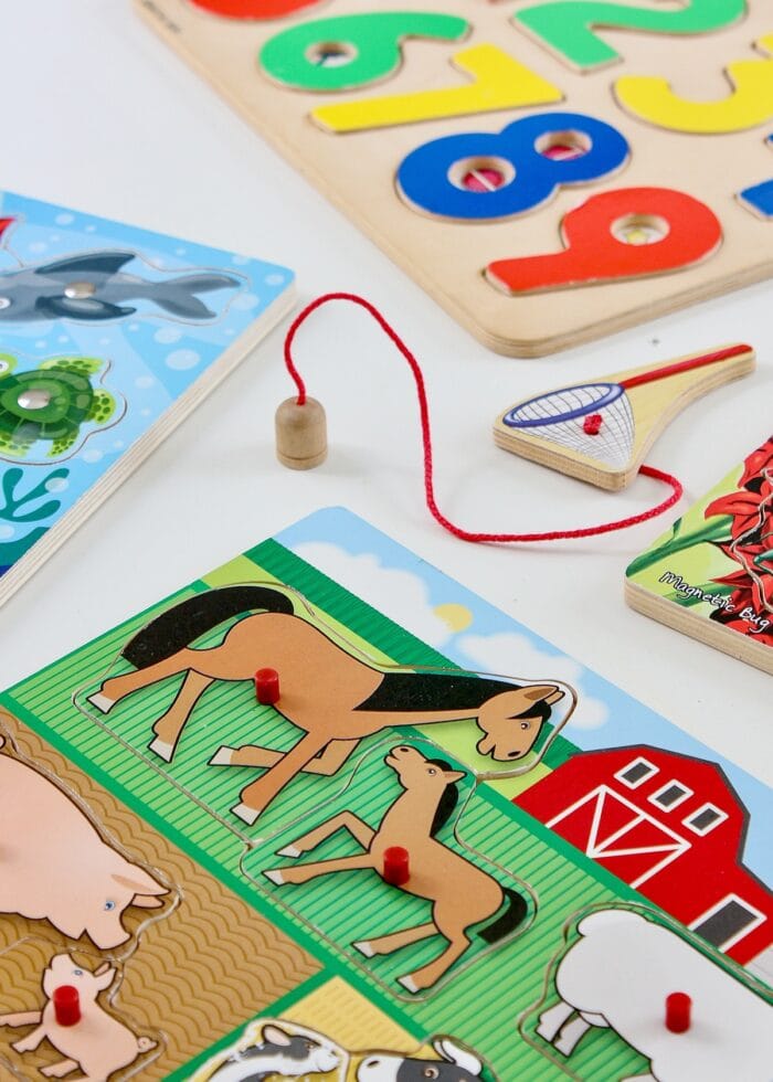 A collection of wooden kid puzzles on a white table