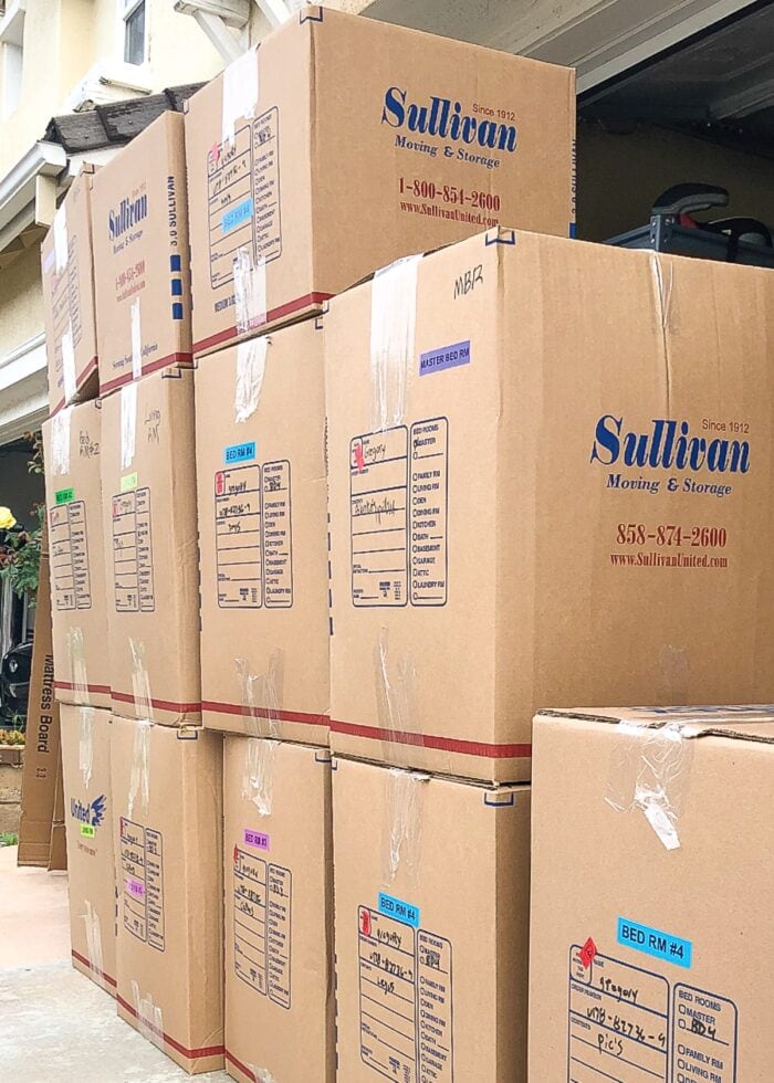 Stacks of moving boxes with color coded labels