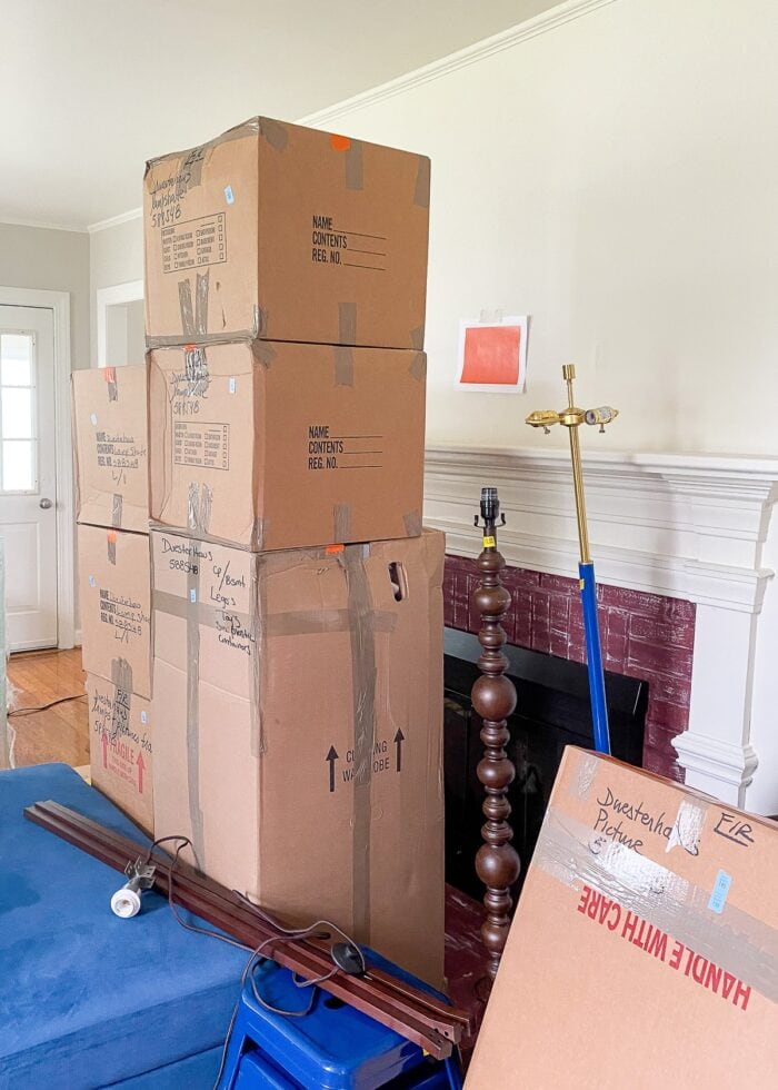 Stacks of moving boxes with lengths of orange tape