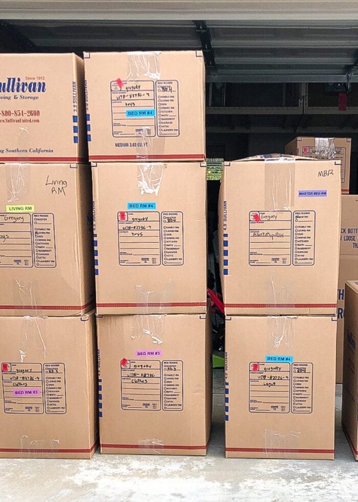 Stacks of moving boxes with color coded labels