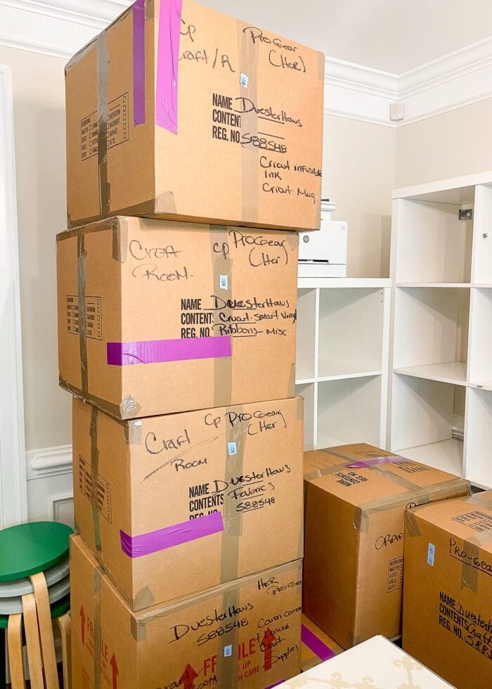 Stacks of moving boxes with purple lengths of tape
