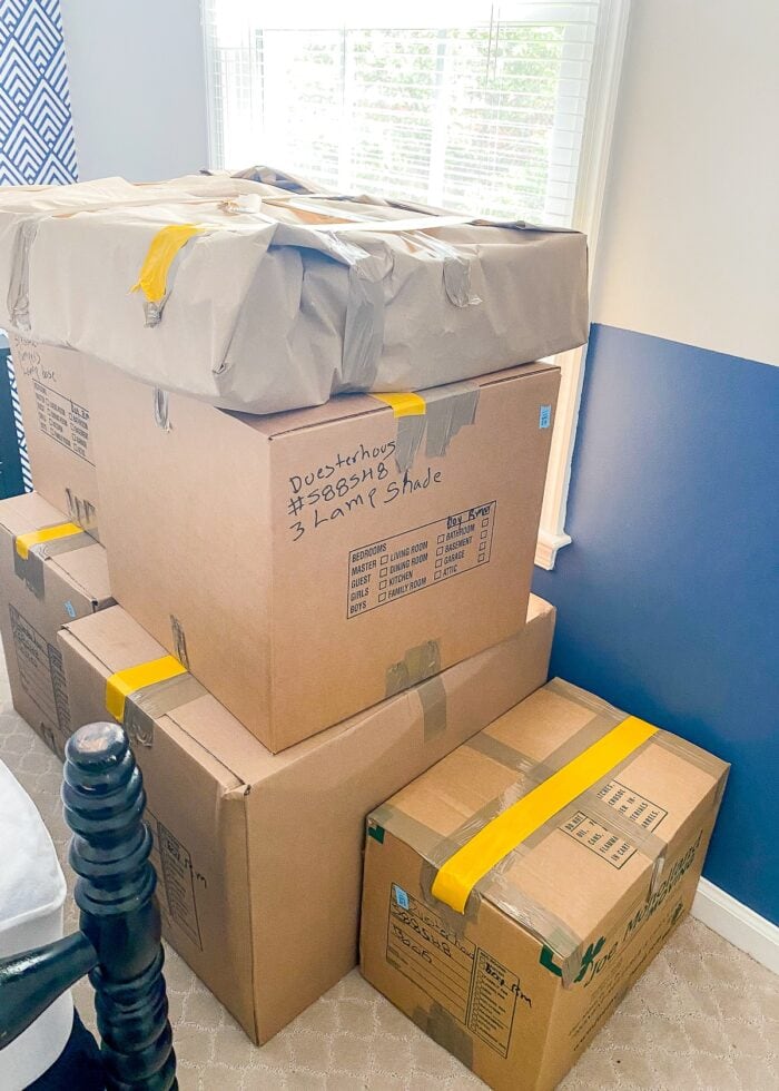 Stacks of moving boxes with yellow lengths of tape