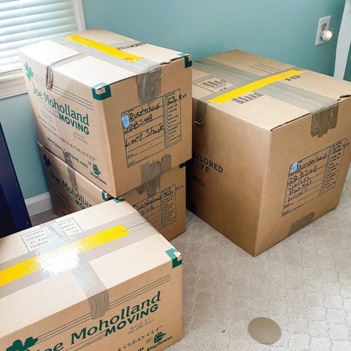 Stacks of moving boxes with yellow lengths of tape