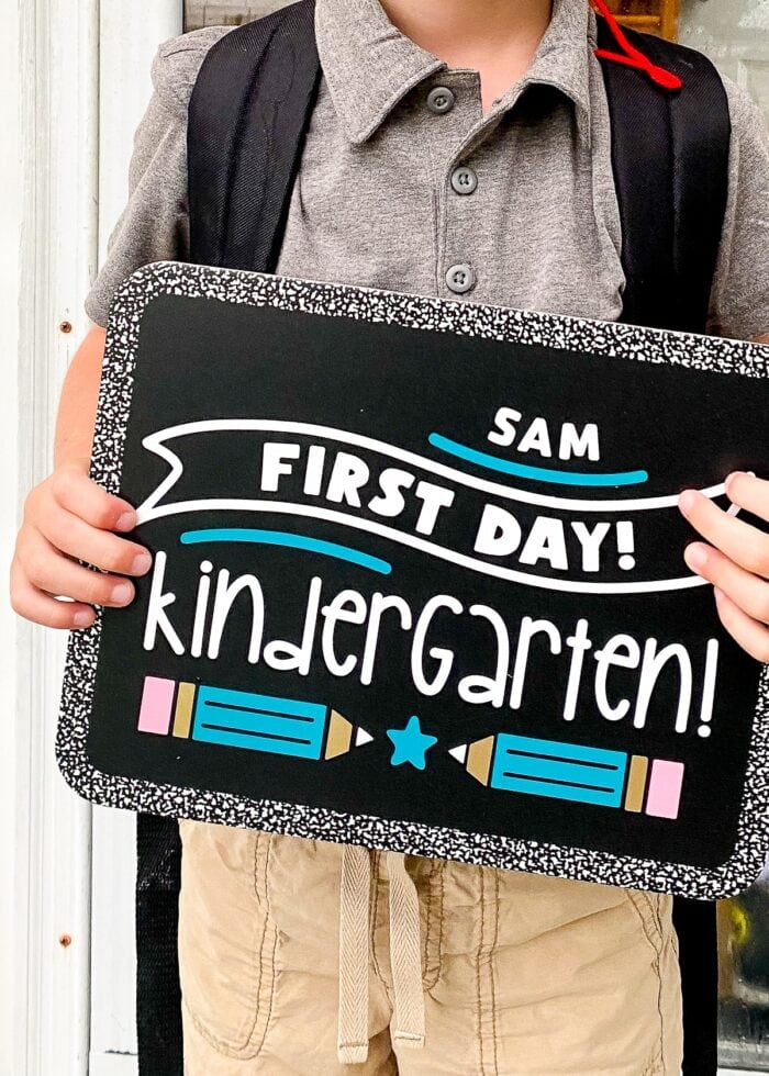 Boy holding First Day of Kindergarten Sign