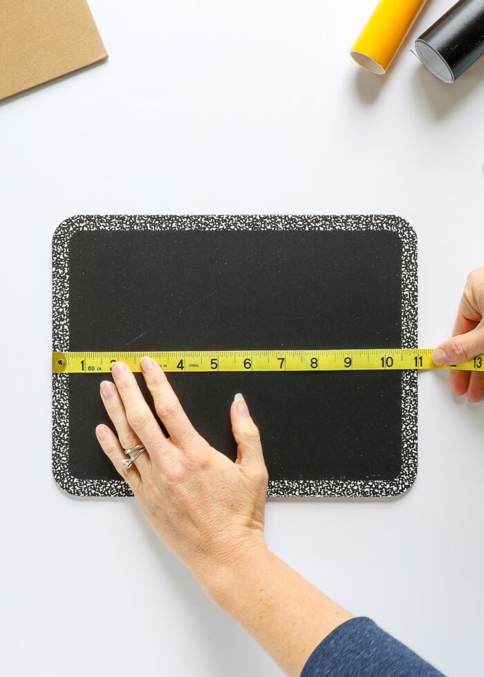 Hands measuring chalkboard sign