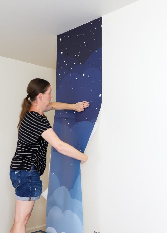 Megan smoothing first wallpaper mural panel
