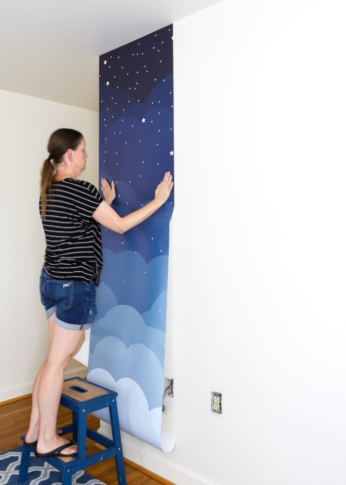 Megan smoothing first wallpaper mural panel