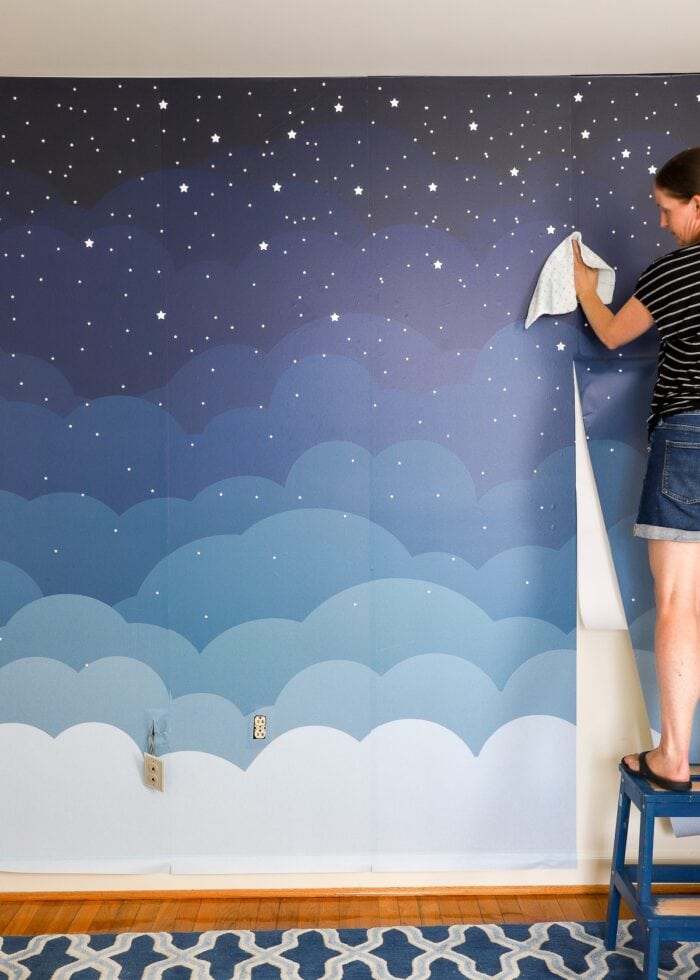 Megan hanging fourth wallpaper mural panel