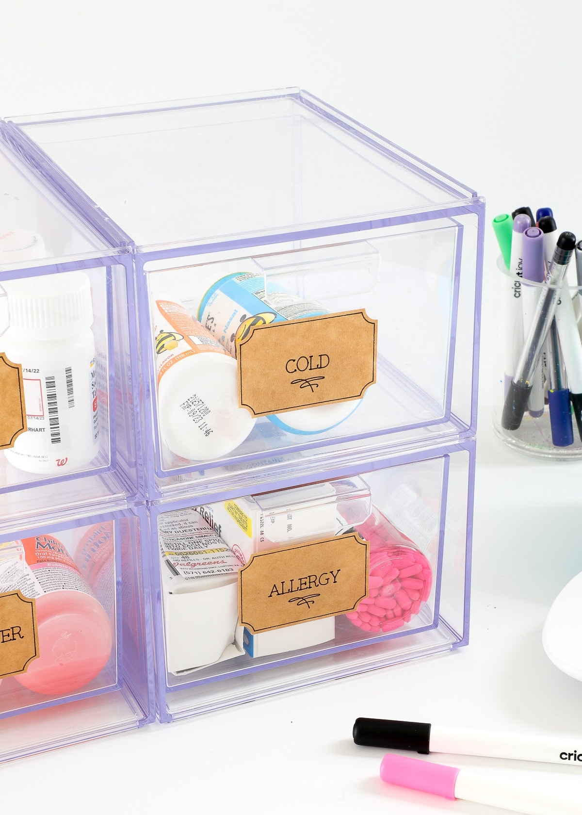 Labels drawn with Cricut Pens on stacking acrylic drawers holding medicine