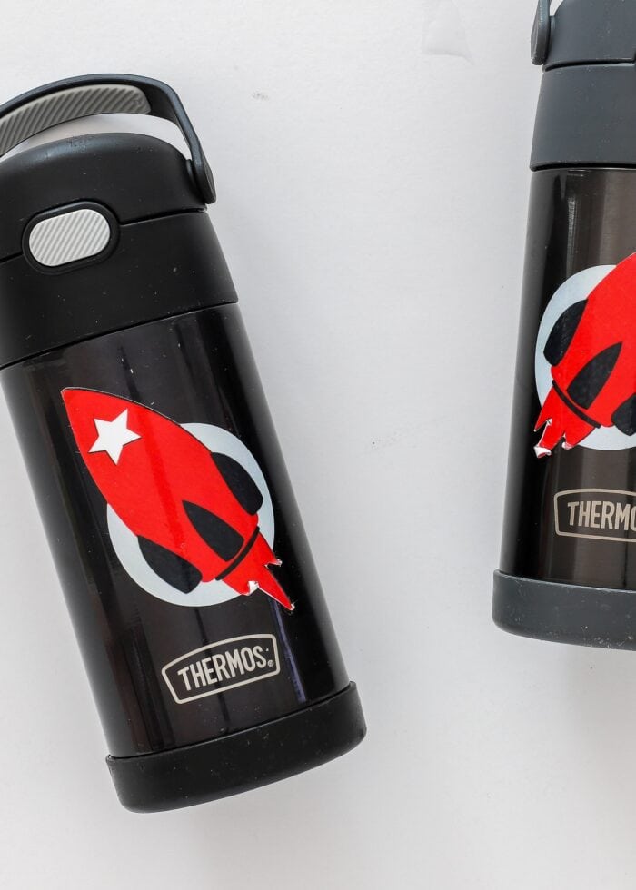 Two water bottles with peeling decals