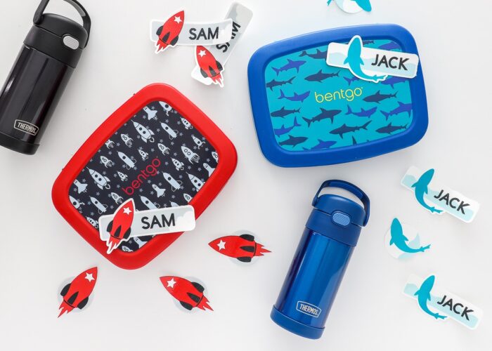 Waterproof stickers made with a Cricut all around lunchboxes and water bottles