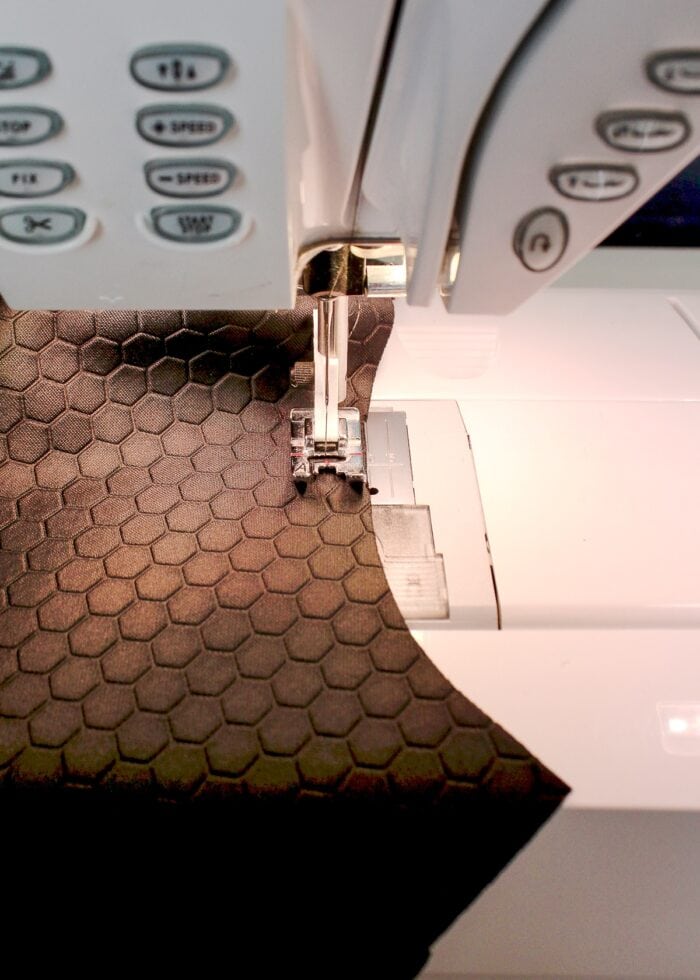 Sewing machine stitching black fabric