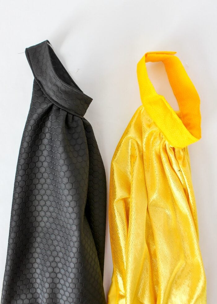 A black and yellow superhero cape side by side
